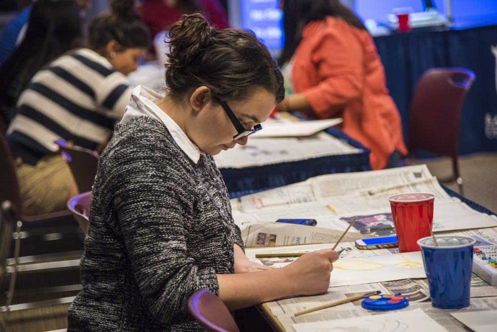Sophomore Stephanie Vance paints a water color picture of a crane. The Asian American Student Association held the water painting event as part of their month of events. DN PHOTO RACHEL BRAMMER