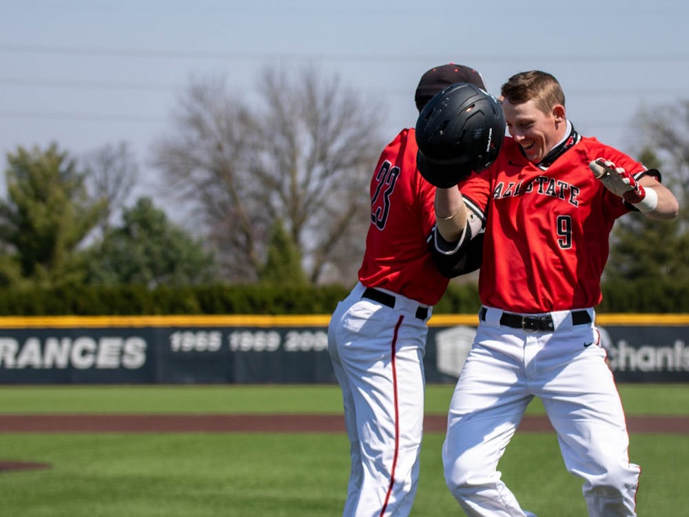 Senior outfielder Ross Messina celebrates with junior outfielder Nick Powell after Powell hit a home run April 3, 2021, at Ball Diamond at First Merchants Ballpark Complex. The Cardinals won their second game of the day 16-10 against the Bulldogs. Jaden Whiteman, DN