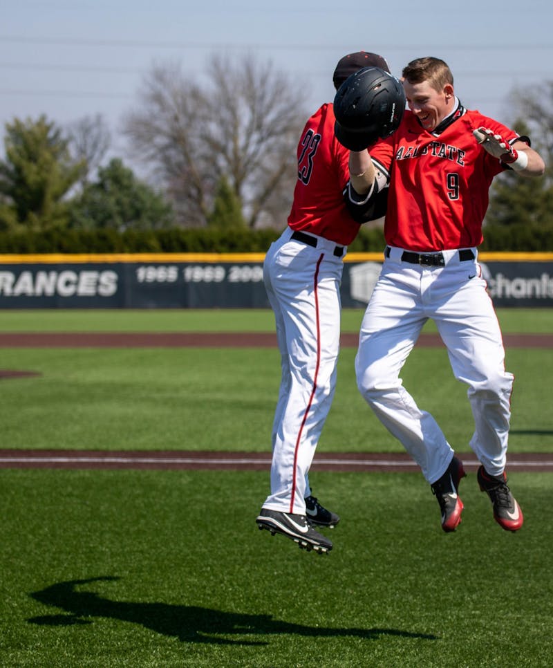 Senior outfielder Ross Messina celebrates with junior outfielder Nick Powell after Powell hit a home run April 3, 2021, at Ball Diamond at First Merchants Ballpark Complex. The Cardinals won their second game of the day 16-10 against the Bulldogs. Jaden Whiteman, DN