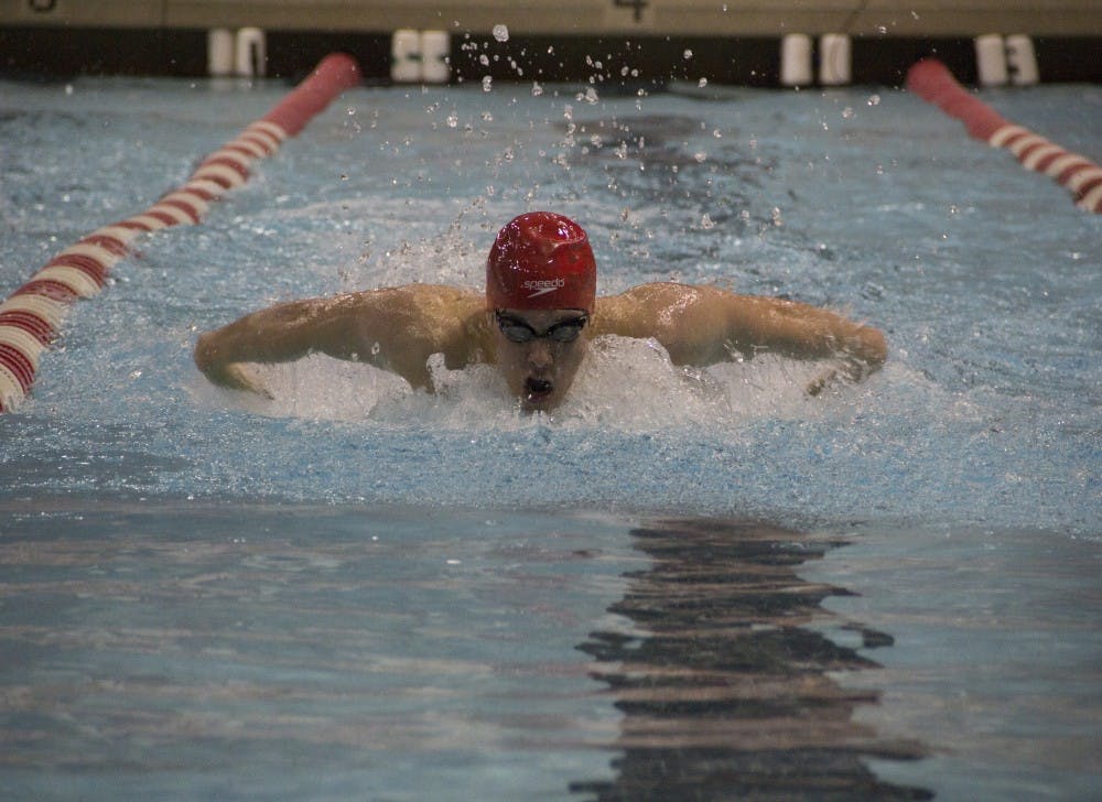 Drew Tharp, a senior, swims the 200-yard butterfly during the meet against Miami. Tharp finished first in his race. DN PHOTO EMMA ROGERS