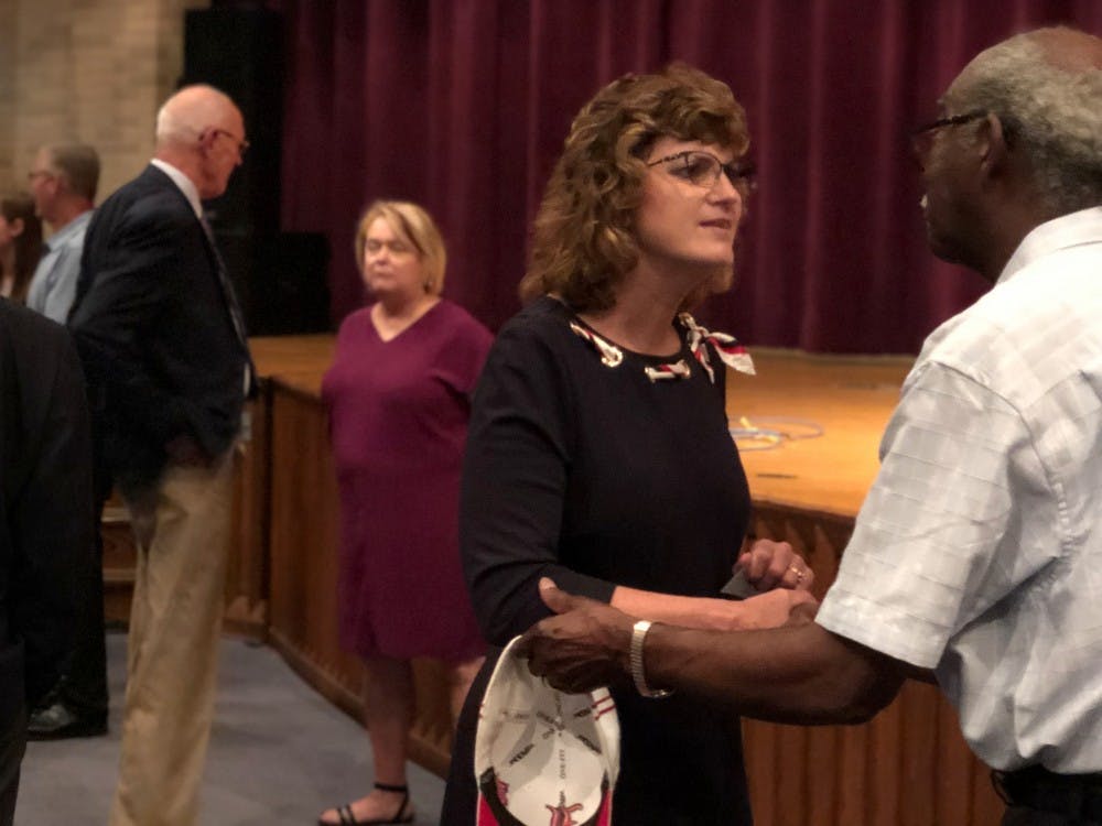 Lee Ann Kwiatkowski interacts with an attendee at the Muncie Community Schools (MCS) special board meeting July 1, 2019, at Muncie Central High School. Kwiatkowski will be the new director of public education and CEO of MCS. Jake Merkel, DN