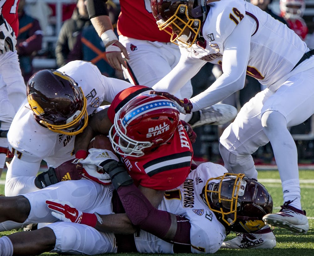 Junior running back Caleb Huntley gets tackled by Central Michigan players Nov.16, 2019, at Scheumann Stadium. Ball State lost to Central Michigan, 45-44. Rebecca Slezak, DN