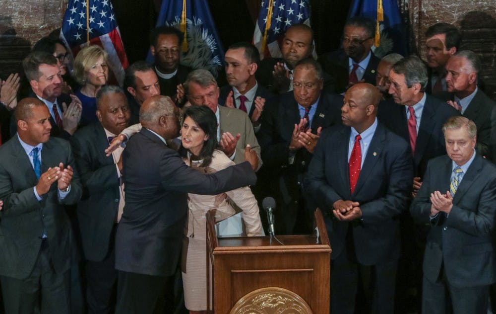 South Carolina Gov. Nikki Haley hugs U.S. Congressman James Clyburn after she called for legislators to remove the Confederate flag from the grounds of the State House during a press conference on Monday, June 22, 2015, in Columbia, S.C. (Tim Dominick/The State/TNS)
