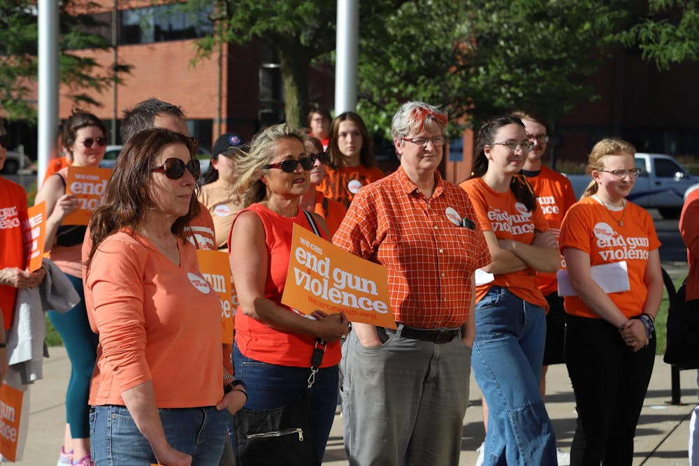 Community members gather at City Hall on June 7 for the "Wear Orange Rally" hosted by Burris High School. Guest speakers shared concerns about gun safety and advocated for stricter gun control laws. Olivia Ground, DN
