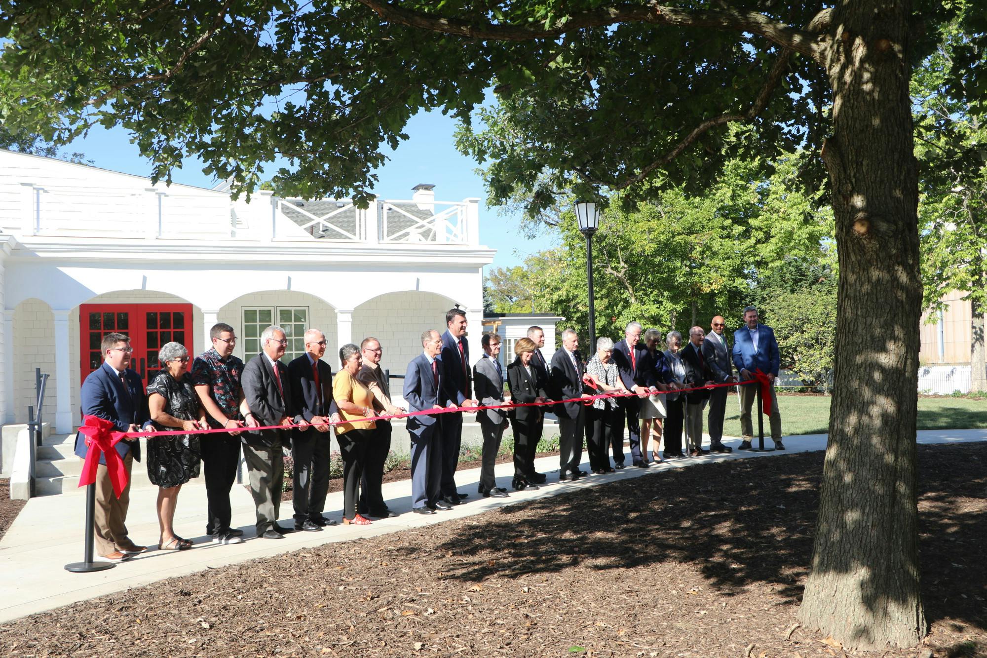 Faculty members and other attendees stand behind the ribbon before the cutting ceremony Sept. 26 at the Edmund F. and Virginia B. Ball Honors House in Muncie, Ind. Gracie Parkhurst, DN