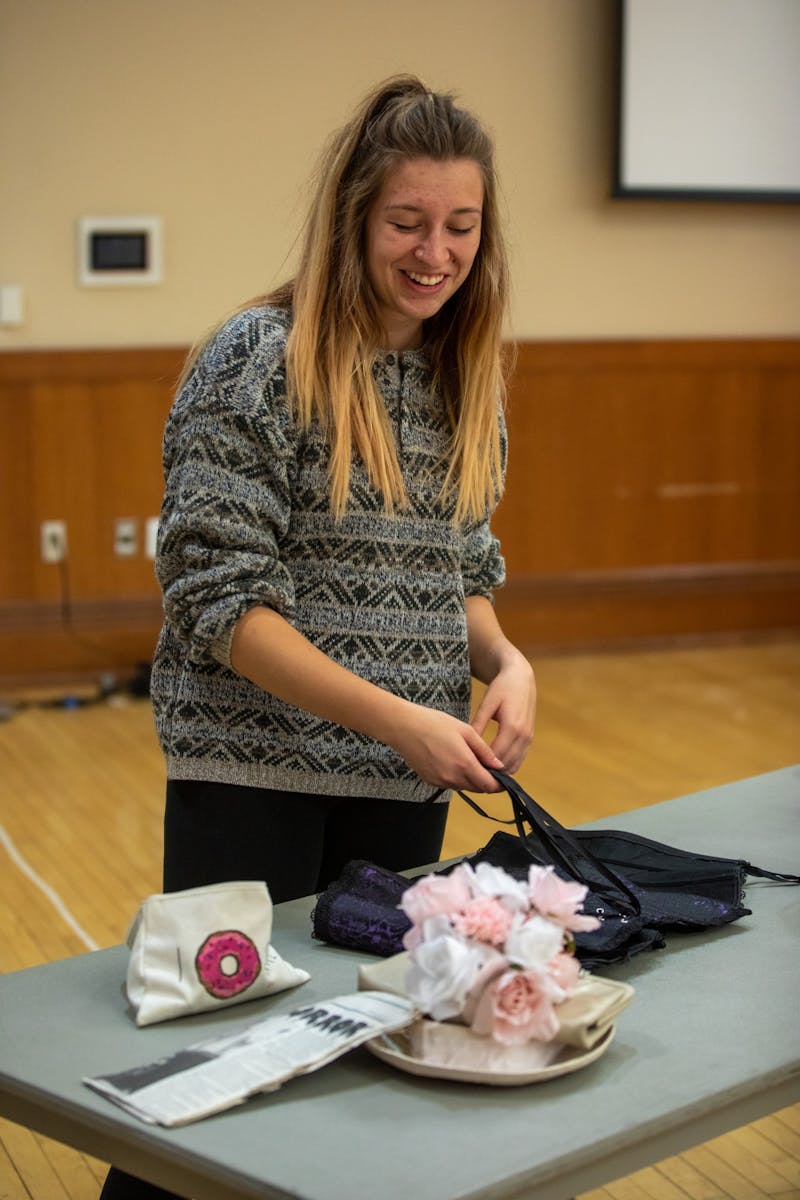 Costume Designer Dee Slagle gets a corset ready for a cast member Oct. 28, 2019, in the Student Center Ballroom. The practice was the last full run of the show the cast had before their show on Halloween. Jacob Musselman, DN&nbsp;