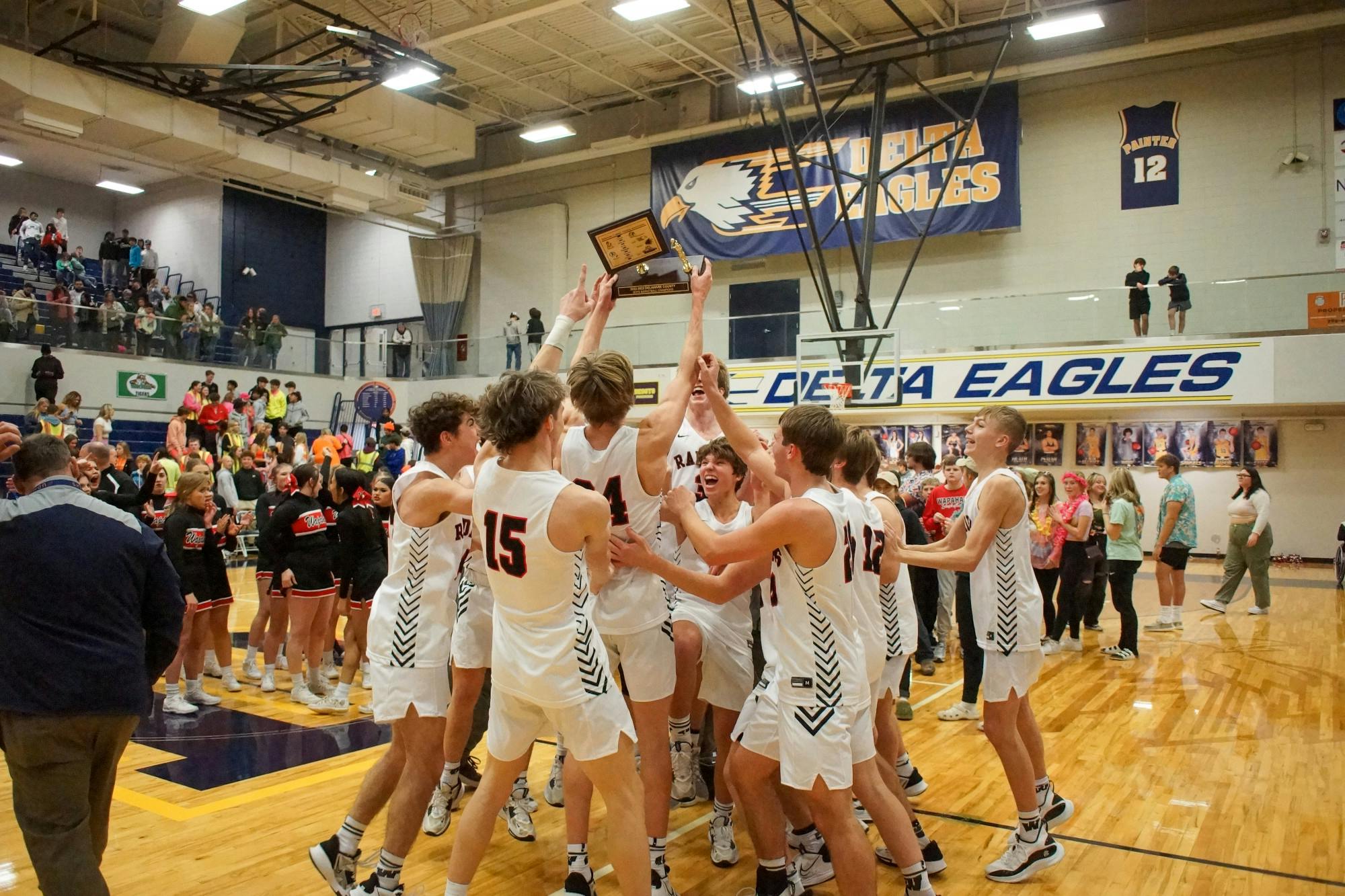 Wapahani Boys Basketball celebrates with the 2023 Delaware County Tournament trophy after defeating Yorktown 62-45 on Jan 14. Daniel Kehn, DN 