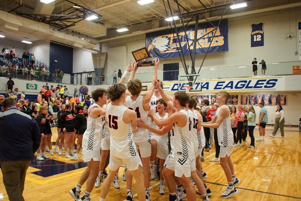 <p>Wapahani Boys Basketball celebrates with the 2023 Delaware County Tournament trophy after defeating Yorktown 62-45 on Jan 14. Daniel Kehn, DN </p>