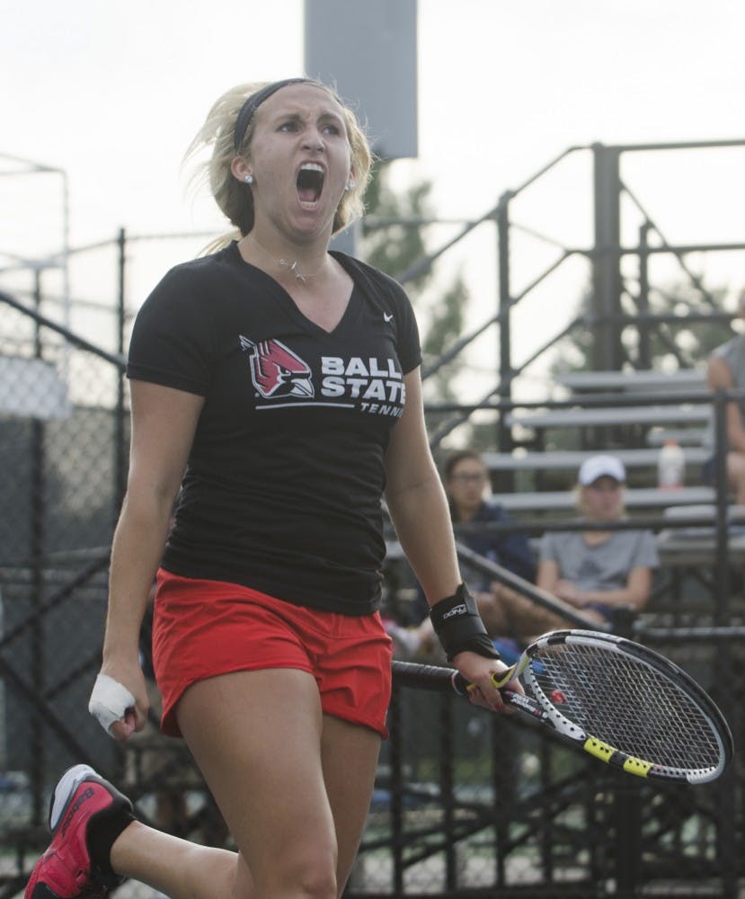 Senior Courtney Wild celebrates after winning her singles match against Butler for the Fall Dual on Sept. 20 at the Cardinal Creek Tennis Center. DN PHOTO BREANNA DAUGHERTY 