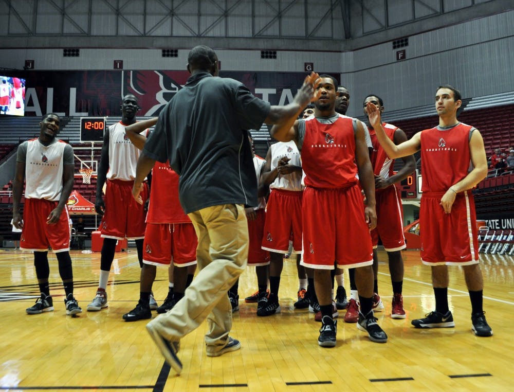 Assistant men's basketball coach Billy Wright swaps high fives with his team during Ball State's Basketball Fan Jam 2013. DN PHOTO REBEKAH FLOYD