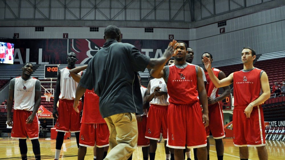Assistant men's basketball coach Billy Wright swaps high fives with his team during Ball State's Basketball Fan Jam 2013. DN PHOTO REBEKAH FLOYD