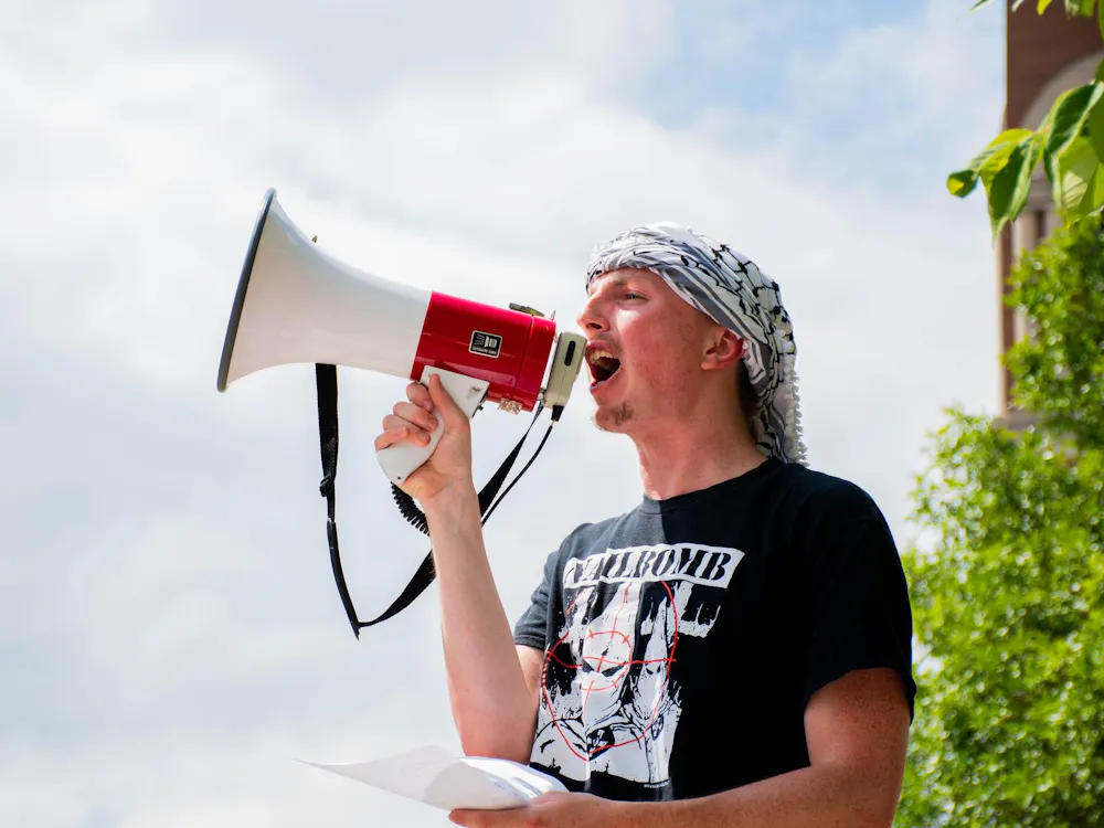 BSU Student Cooper Archer was not only protesting, but also one of the active speakers. He stood up several times using a script that contained chants for the other protestors. Kadin Bright, DN.