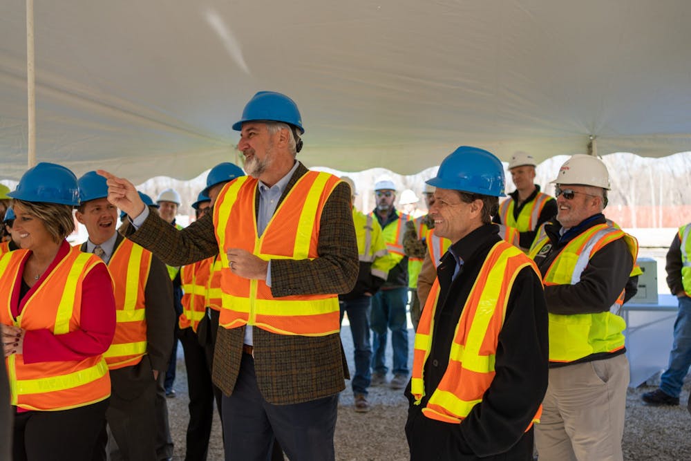 Gov. Eric Holcomb, middle, and Secretary of Commerce Brad Chambers, right, celebrate the groundbreaking of an $84 million semiconductor facility in Odon. (Photo from Holcomb’s Flickr)