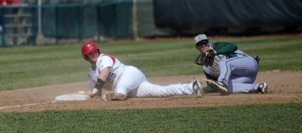 Freshman Jarett Rindfleisch and an Eastern Michigan player look to an official for a call April 5 at Ball Diamond. Rindfleisch had two RBIs in the losing game against Indiana State on May 6.  DN FILE PHOTO BREANNA DAUGHERTY