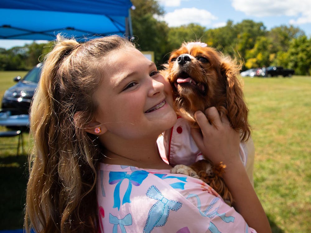 London Braun holds her dog Lola at the Grateful Tail Wagging Showcase Sept. 7 in Yorktown Ind. London and her mother, Emily Braun, won the dog costume contest. Jessica Bergfors, DN