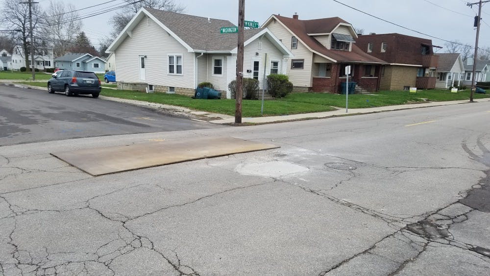 <p>After a sinkhole was discovered at North McKinley Avenue and West Washington Street Thursday, crews temporarily repaired it Friday to reopen the road. <strong>Nick Williams, DN Photo&nbsp;</strong></p>