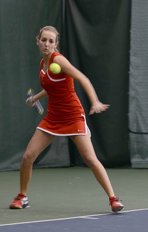 Courtney Earnest positions herself for a swing during her Singles match against Milwaukee University player Chelsea Bailey. Even though Earnest lost her Doubles match, she overtook her opponent in singles. DN PHOTO ABRAHAM FALCON