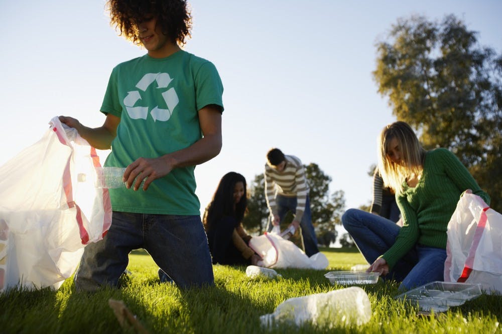 Teens Picking Up Trash in Field