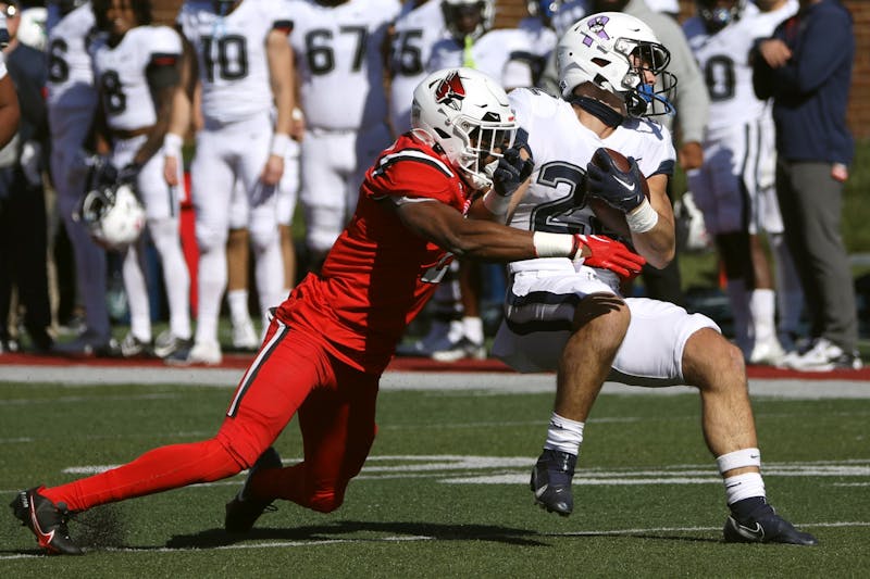 Fourth-year safety Malcolm Lee (left) tackles first-year running back for University of Connecticut Victor Rosa (right) Oct. 15 at Scheumann Stadium. Lee had four solo tackles during the game. Amber Pietz, DN