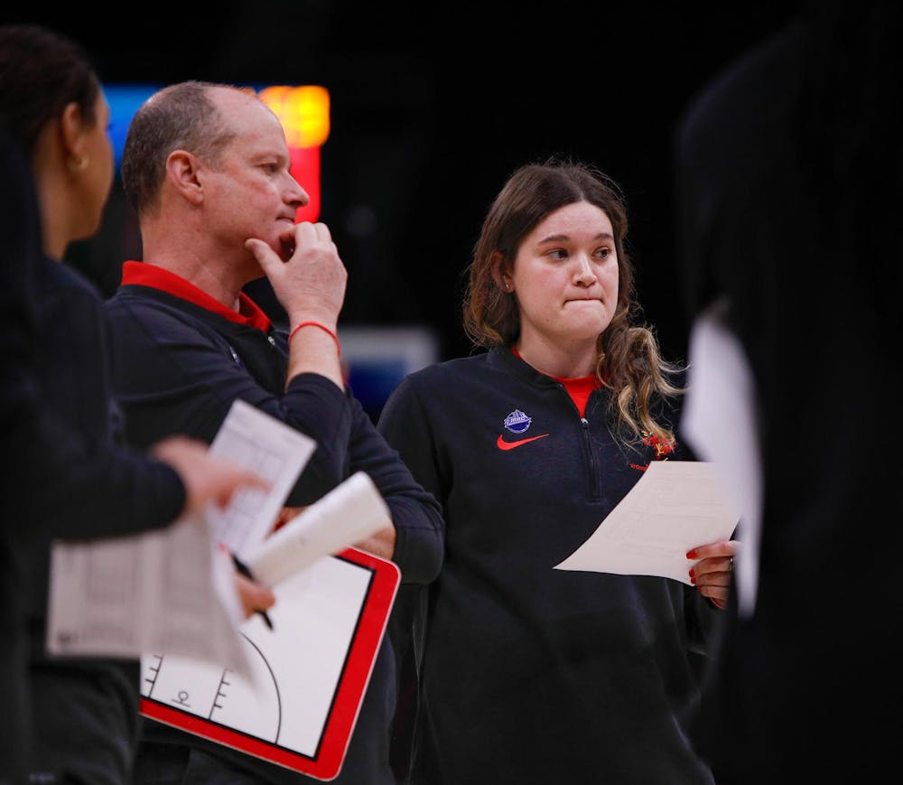 Head coach Brady Sallee and assistant coach Moriah Monaco talk about their plans after timeout against Kent State March 15 at Rocket Mortgage Feildhouse in Cleveland, Ohio. Andrew Berger, DN