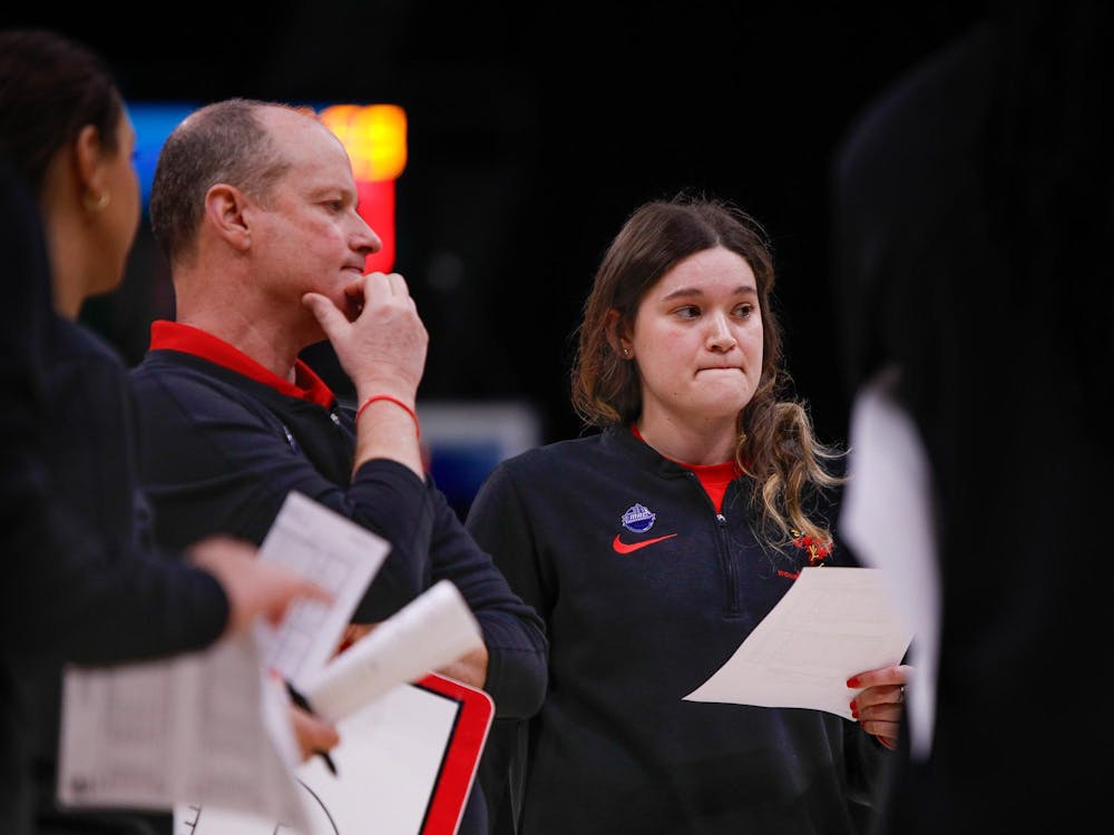 Head coach Brady Sallee and assistant coach Moriah Monaco talk about their plans after timeout against Kent State March 15 at Rocket Mortgage Feildhouse in Cleveland, Ohio. Andrew Berger, DN