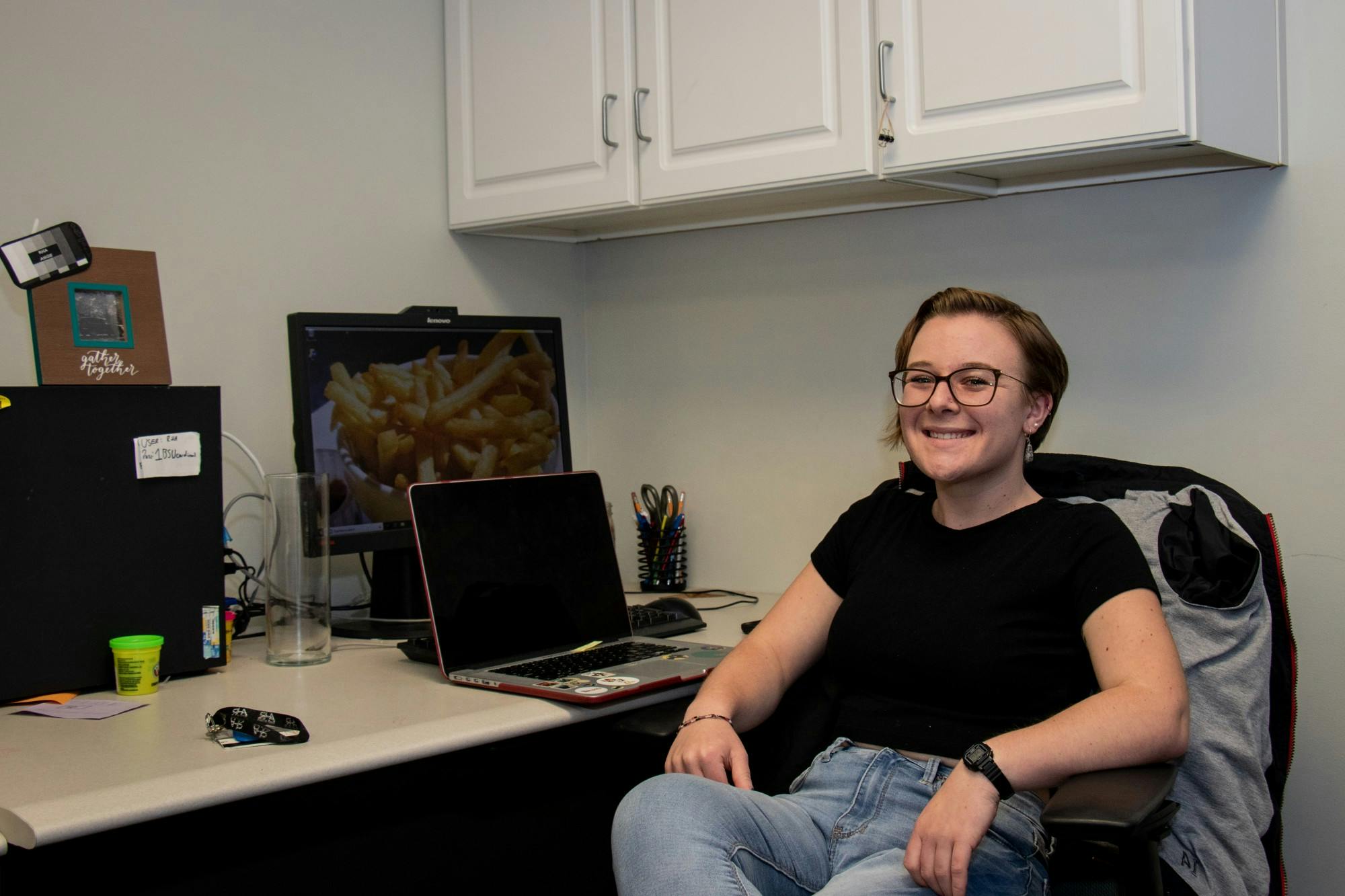 Senior Jackie Weisenfelder sits at a desk in the Residence Hall Association's (RHA) office. Weisenfelder joined the RHA's executive board as a sophomore and has since become the organization's president. Eric Pritchett, DN
