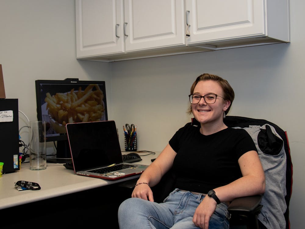 Senior Jackie Weisenfelder sits at a desk in the Residence Hall Association's (RHA) office. Weisenfelder joined the RHA's executive board as a sophomore and has since become the organization's president. Eric Pritchett, DN