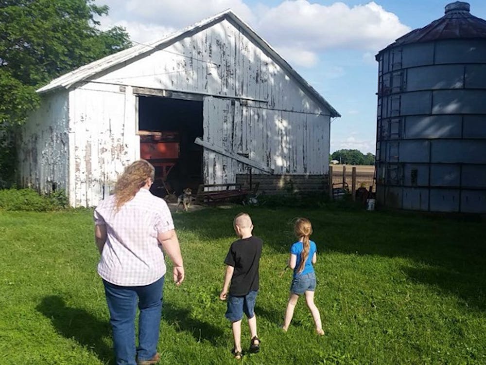 Tana Pittsford walks to the family sheep barn with her grandchildren, Wyatt and Kaylee Pitsfords. The Pittsfords are a six-generation 4-H family from Yorktown, Ind. who participated at the Indiana State Fair this summer. LAURA ARWOOD / BSU JOURNALISM AT THE FAIR 