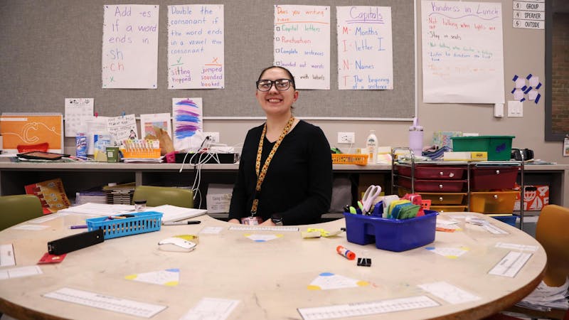  First-grade teacher Savannah Oliphant poses for a photo at one of the tables in her classroom Feb. 27 at East Washington Academy in Muncie, Indiana. Oliphant is in her second year of teaching at Muncie Community Schools. Mya Cataline, DN