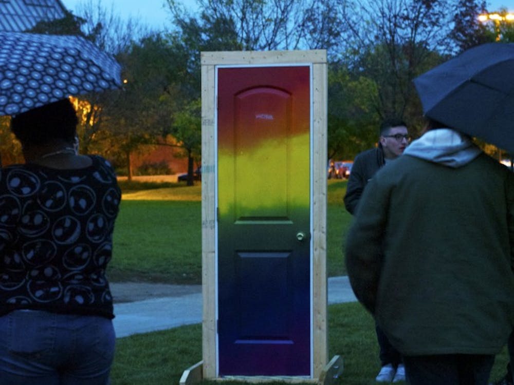 At National Coming Out Day on Oct. 10 on University Green, students would walk through the rainbow-colored door and then tell their personal stories of how they came out to their peers. DN PHOTO SAMANTHA BRAMMER