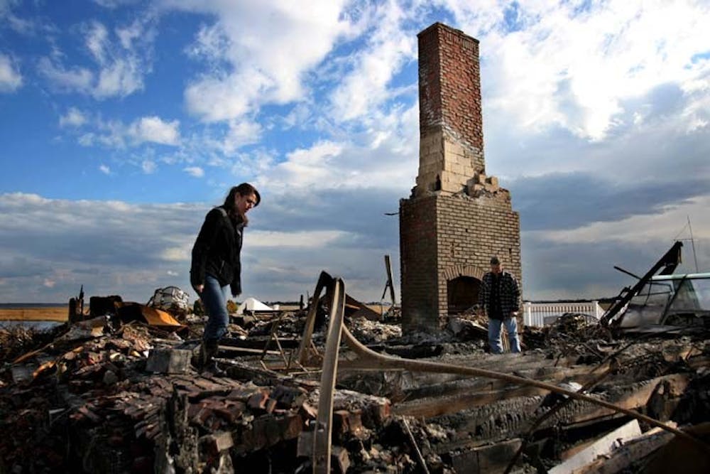Sal Quartucio, right, shown with niece Rachel Krinner, looks for belongings among the ashes of what use to be his home on Friday in Bayville, N.J. Sal and Elaine Quartucio’s home burned down the night Hurricane Sandy hit the surrounding area. MCT PHOTO