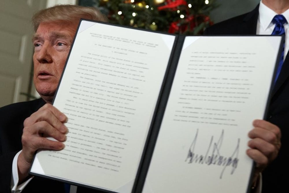 <p>President Donald Trump holds up a proclamation to officially recognize Jerusalem as the capital of Israel, in the Diplomatic Reception Room of the White House, Wednesday, Dec. 6, 2017, in Washington. <strong>AP Photo, Photo Courtesy</strong>&nbsp;</p>