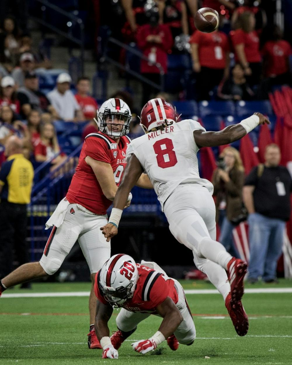 <p>Ball State redshirt junior quarterback Drew Plitt throws a pass as an Indiana defender breaks past the line of scrimmage Aug. 31, 2019, in Lucas Oil Stadium in Indianapolis. After a close first half, Indiana walked away defeating the Cardinals, 34-24, in the season opener. <strong>Eric Pritchett, DN</strong></p>