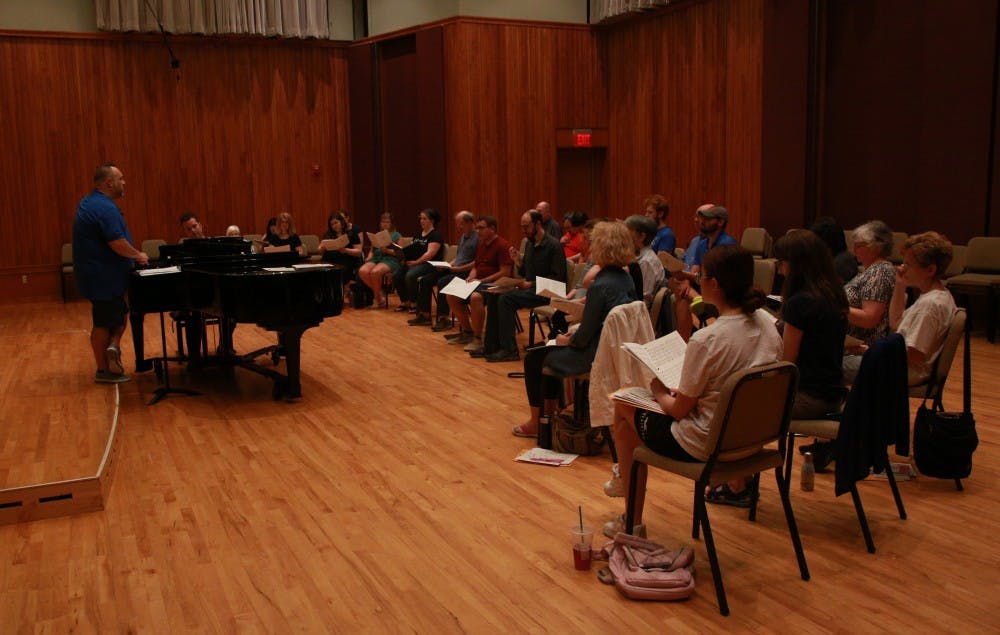 Alan Alder, music instructor and director of University Singers, leads a practice session of the summer chorus alongside Peter Douglas on the piano June 24, 2019, at Hahn Recital Hall. The summer chorus will perform at a free concert open to the public 7:30 p.m. July 16 at Sursa Performance Hall. Rohith Rao, DN