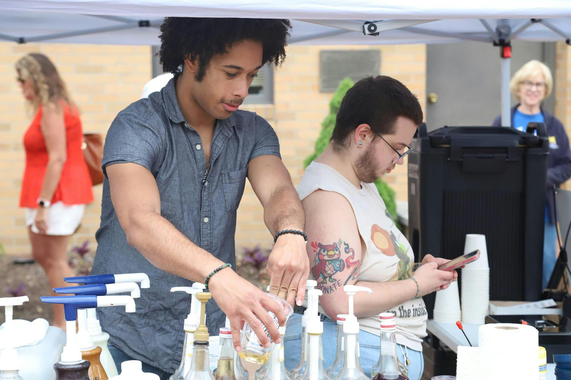 Vendors from Rosebud Coffeehouse make drinks and take orders June 8 during the farmers market at the Minnetrista Museum and Gardens in Muncie. Rosebud Coffeehouse is located at South Hoyt Avenue in Muncie. Olivia Ground, DN