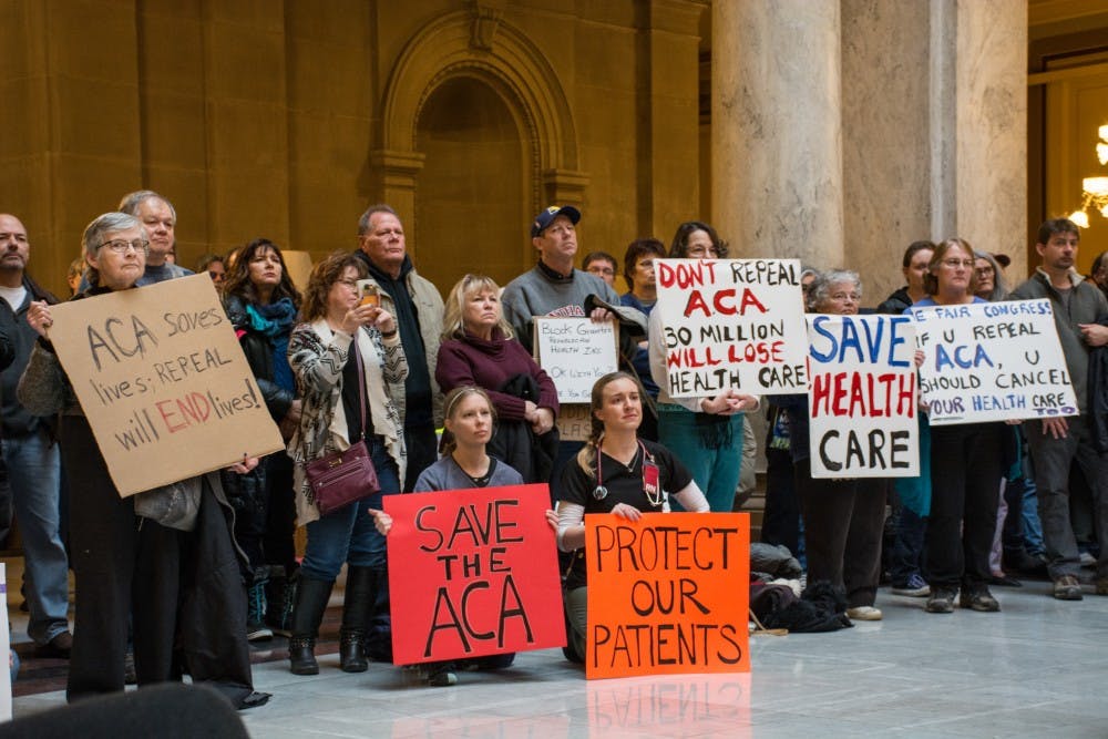 Attendees at the Bernie Sanders Rally hold up signs on Jan. 15 in the Indiana Statehouse. Kaiti Sullivan // DN