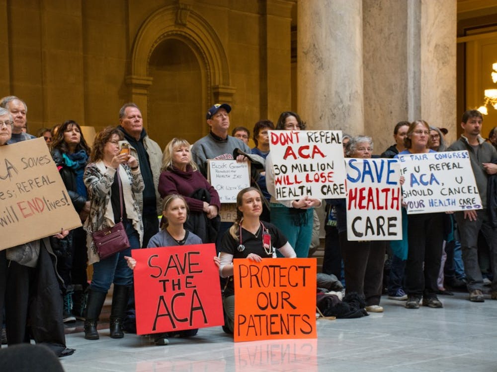Attendees at the Bernie Sanders Rally hold up signs on Jan. 15 in the Indiana Statehouse. Kaiti Sullivan // DN