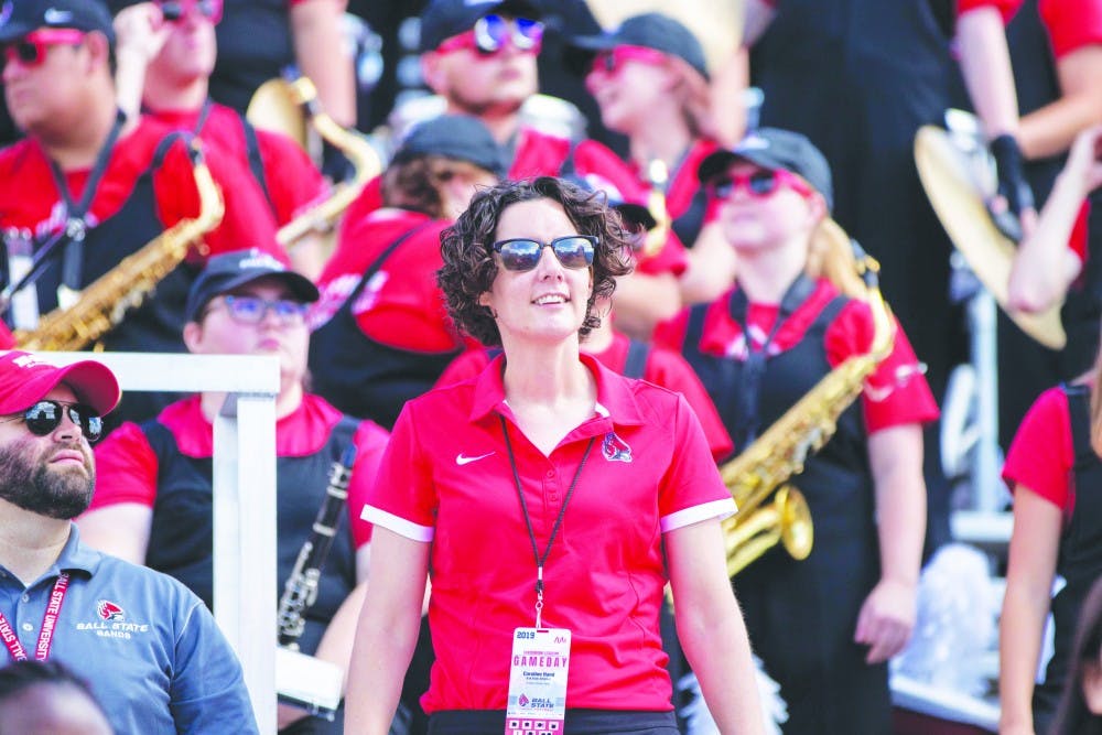 Caroline Hand, director of the Pride of Mid-America (POMA) Marching Band, watches the jumbotron, Sept. 7, 2019, at Scheumann Stadium. Hand is the first female director of POMA at Ball State. Jacob Musselman, DN