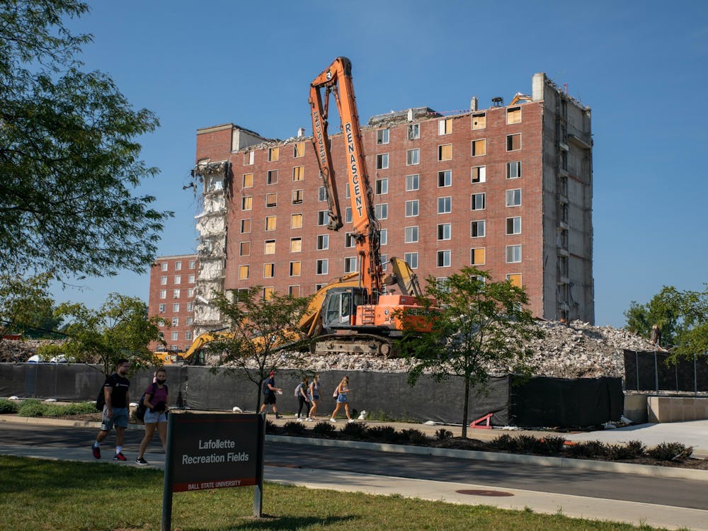 A Renascent mini excavator sits on top of a pile of rubble in front of the LaFollette Complex Sept. 8, 2020. Renascent workers have been demolishing LaFollette since summer 2017. Jaden Whiteman, DN