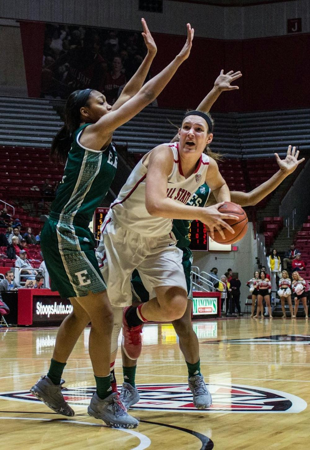 Ball State center Renee Bennett tries to get around two Eastern Michigan players to shoot a layup during the game on Jan. 18 in Worthen Arena. The Cardinals won 78-49. Grace Ramey // DN