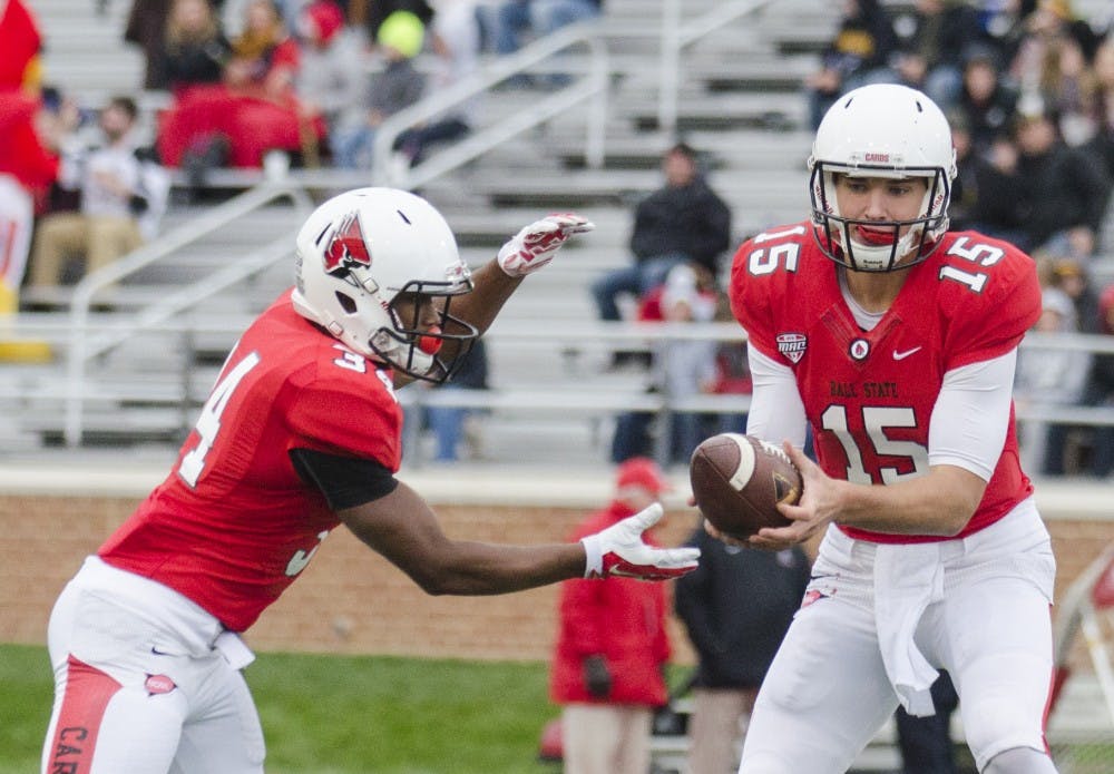 Freshman quarterback Riley Neal hands the ball off to freshman running back James Gilbert during the game against Toledo on Oct. 2 at Scheumann Stadium. DN PHOTO BREANNA DAUGHERTY