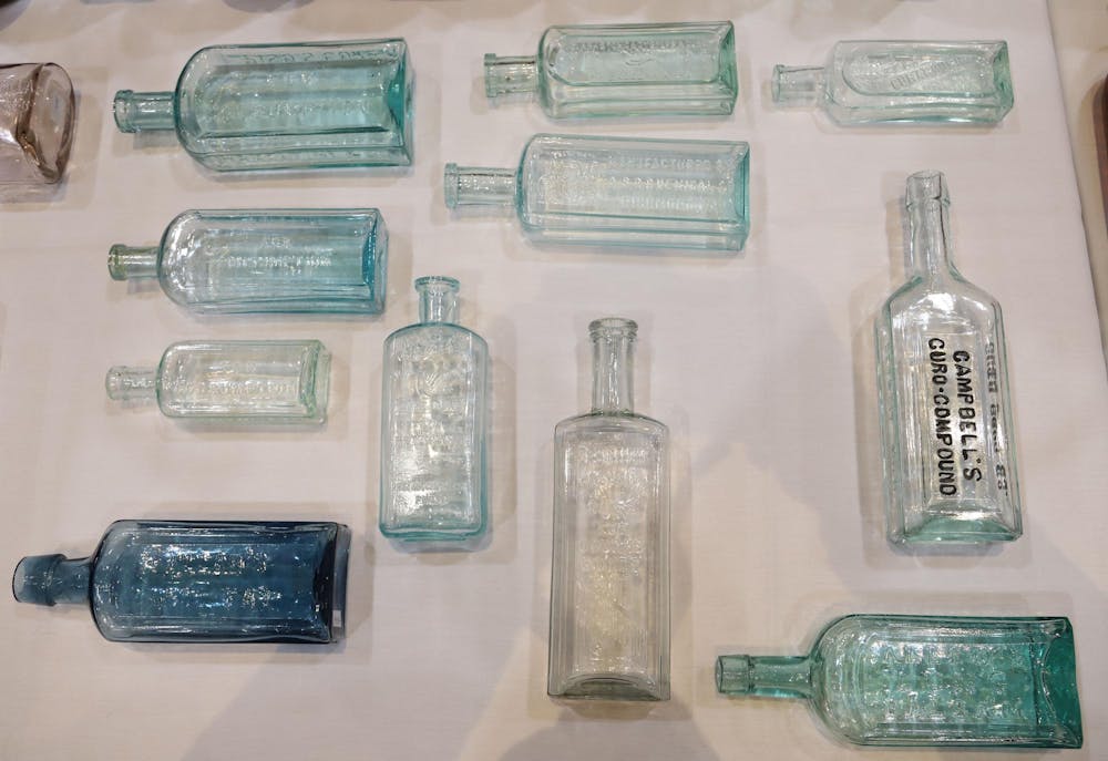 A collection of various medicinal glass jars are displayed at the closing trade show at The Midwest Antique Fruit Jar and Bottle Club – 2024 Convention at the Horizon Convention Center in Downtown Muncie Jan. 20. Olivia Ground, DN