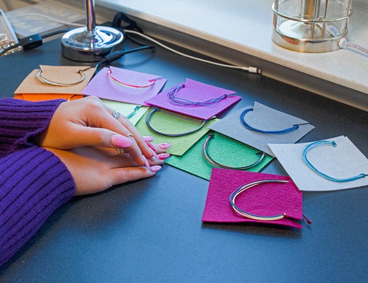 Inspired to learn about Afghanistan and the global refugee crisis, Mazie Wathen started crafting bracelets to ultimately donate the profits for those in need. Here she displays the finished products. (Katie Catterall)