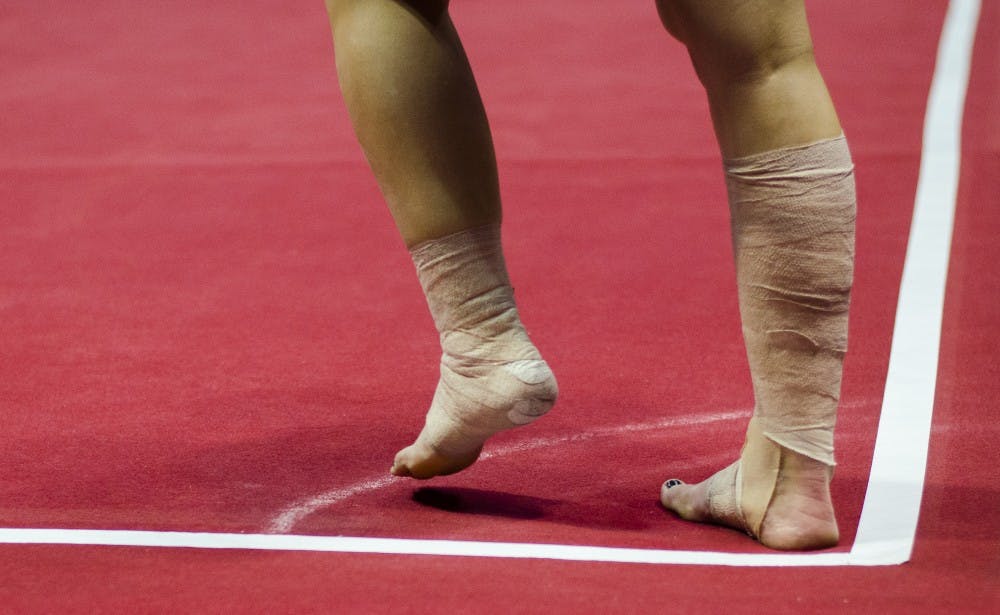 Junior Kayla Beckler prepares to perform a stunt in her floor routine during the meet against Eastern Michigan and Illinois State on Jan. 24 in Worthen Arena. DN PHOTO BREANNA DAUGHERTY