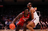 Senior center Payton Sparks drives with the ball against Dayton University Nov. 13 in Dayton, Ohio. Sparks had four points in the game. Andrew Berger, DN 