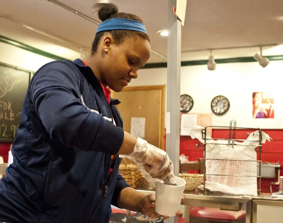 Muncie Central High School student Katiana Wilbanks scoops ice cream Wednesday at Grandma Betty’s Ice Cream Shop. Grandma Betty’s is giving away free ice cream until Friday to clear out the stocks before the shop closes for the season. DN PHOTO JONATHAN MIKSANEK