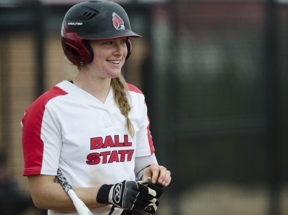 Sophomore catcher Olivia Huffman smiles before her turn at bat during the second game of the double-header against Northern Illinois on April 4 at the Softball Field at the First Merchants Ballpark Complex. Huffman hit a home run during the first game of the double-header. Emma Rogers // DN