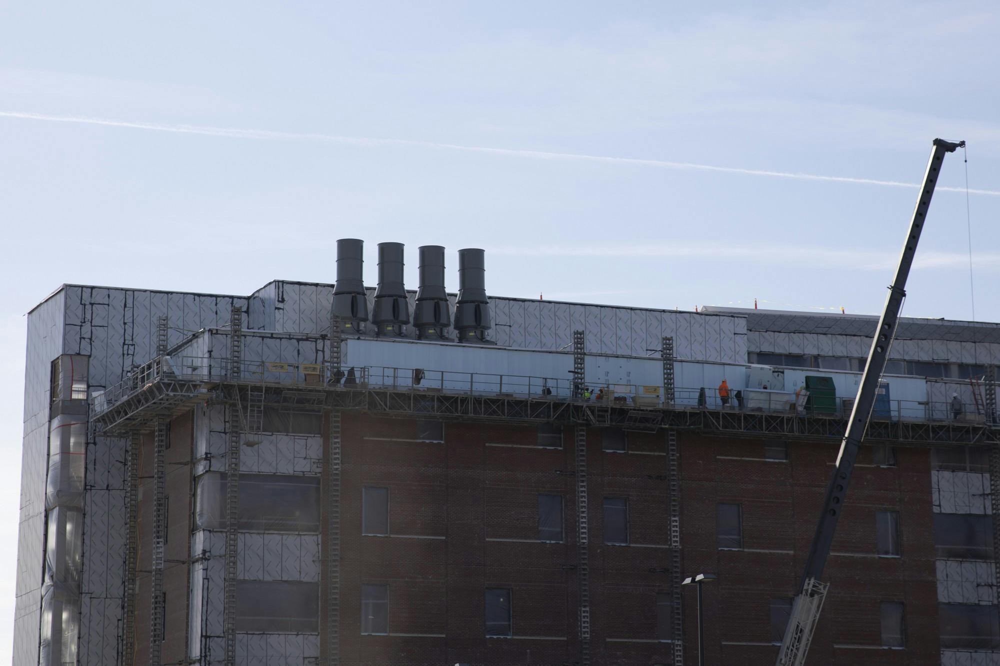 Construction employees work at the top of the new Health Professions building Nov. 18, 2020, at Ball State. The new building will be the replacement to the old Cooper Science Complex, that will be partially demolished and partially renovated. Jacob Musselman, DN