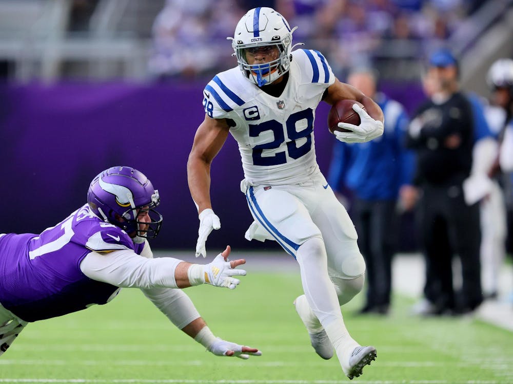 MINNEAPOLIS, MINNESOTA - DECEMBER 17: Jonathan Taylor #28 of the Indianapolis Colts carries the ball against the Minnesota Vikings during the first quarter at U.S. Bank Stadium on December 17, 2022 in Minneapolis, Minnesota. (Photo by Adam Bettcher/Getty Images)
