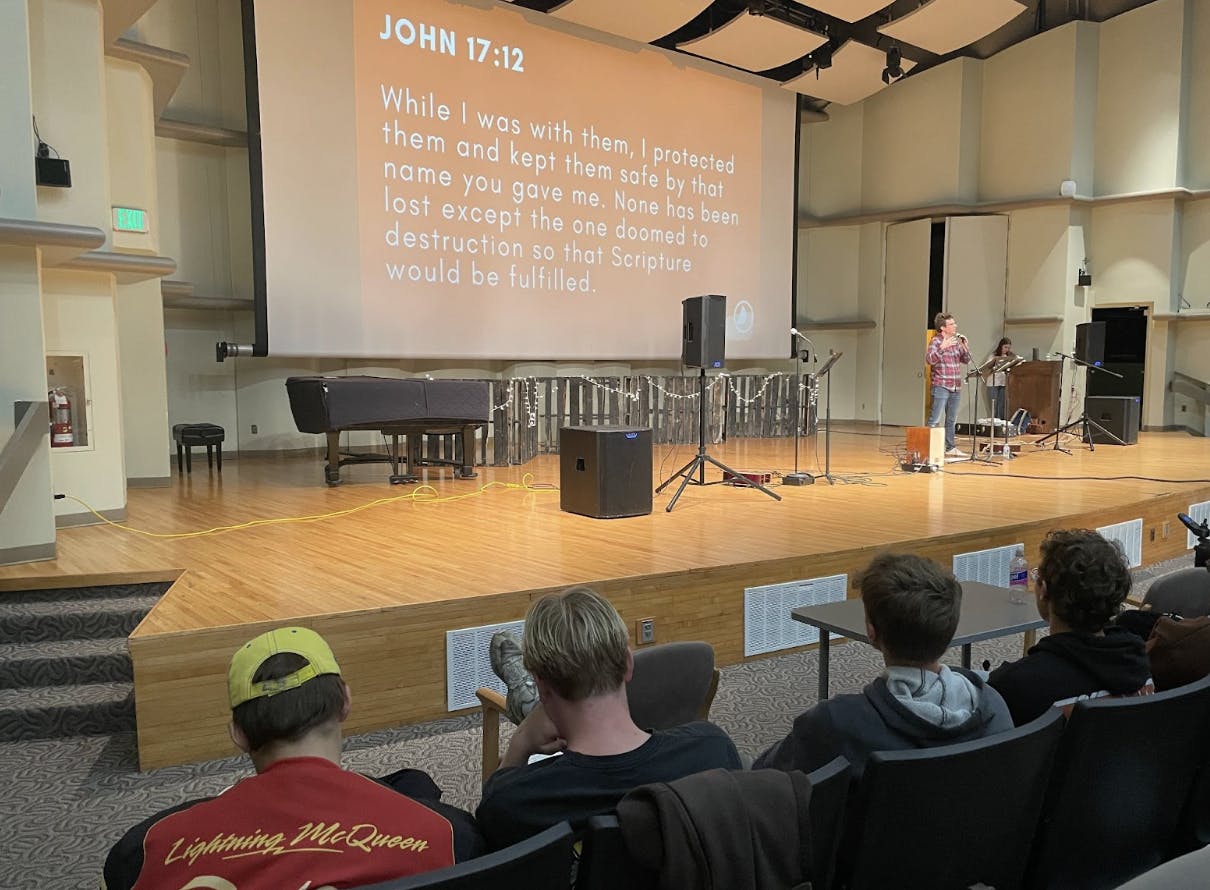 Navigators listen to a message from speaker Logan Watson. 
